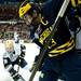 Michigan senior center A.J. Treais fights for the puck on the boards in the game against Notre Dame on Sunday, March 24. Daniel Brenner I AnnArbor.com